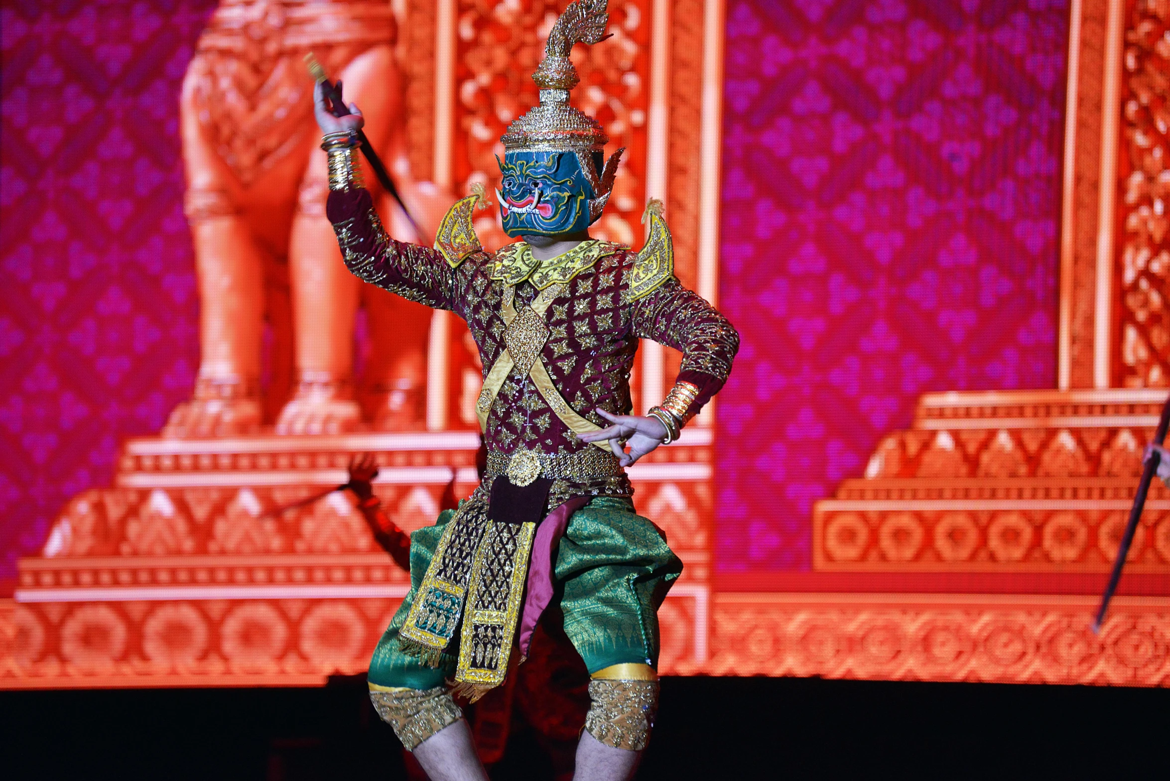 a man in a traditional indian outfit on stage