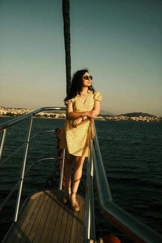 a woman on a boat in the water wearing sunglasses