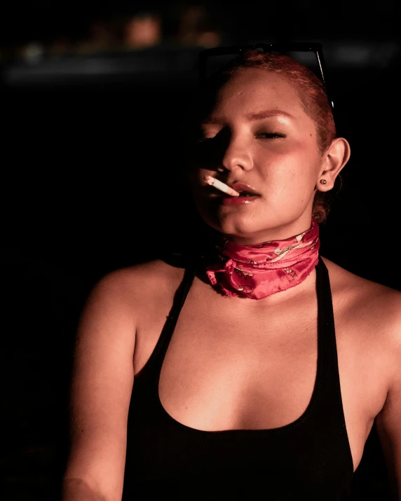 the young lady is wearing a neck scarf and smoking a cigarette