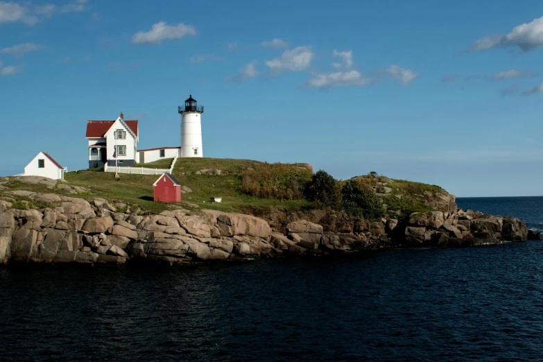 a large red and white house near a body of water