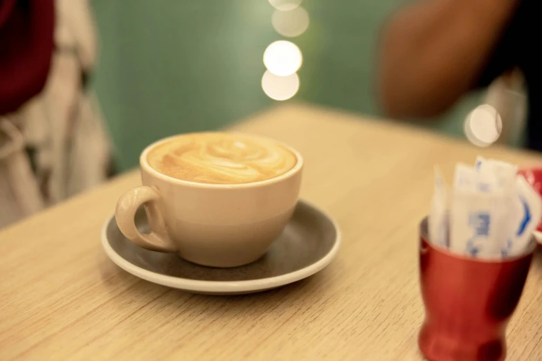 cup and saucer with a small coffee in it