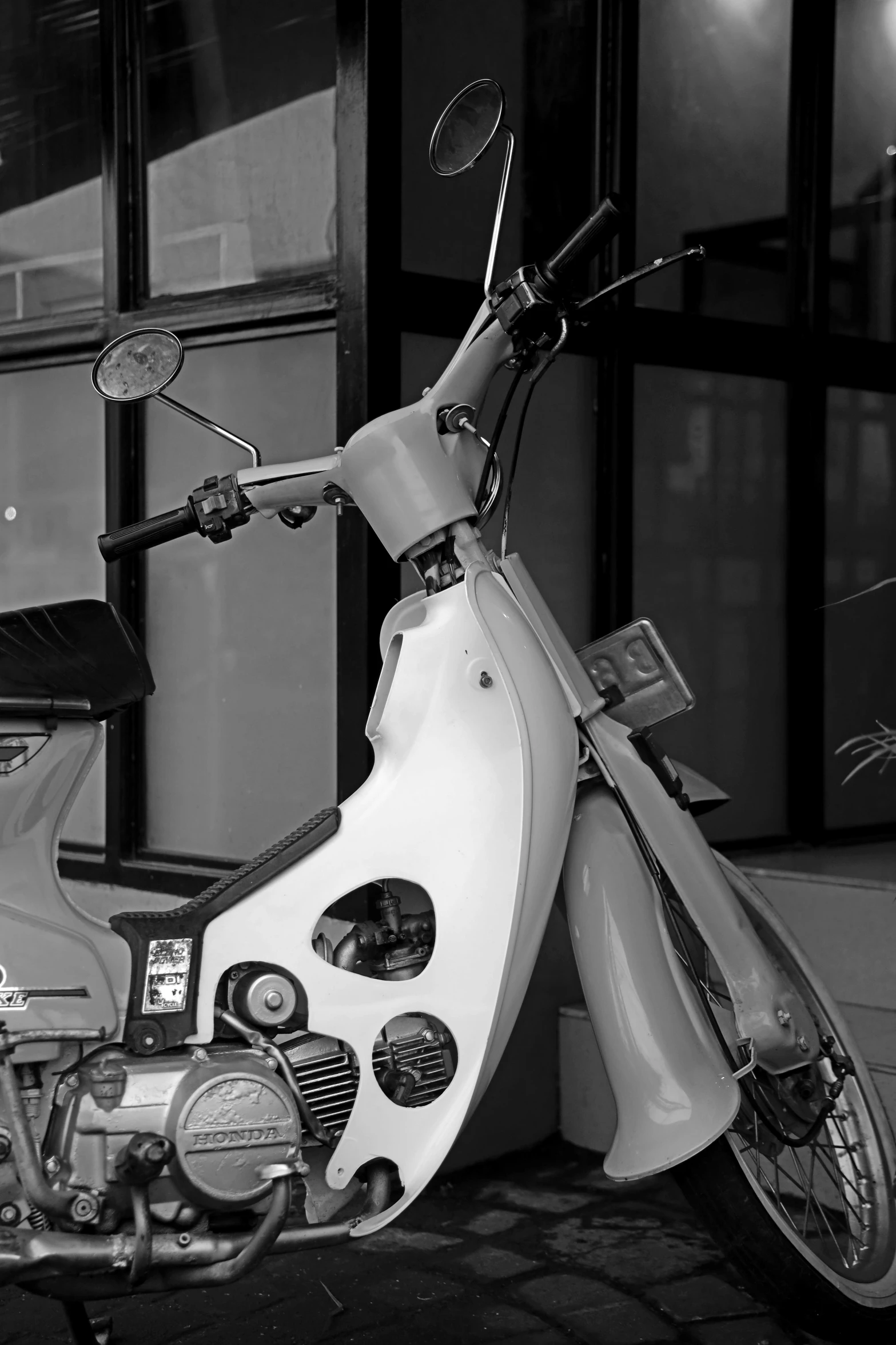 an old motorcycle parked next to a tall building