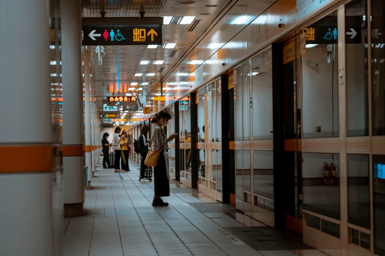 a large group of people waiting at the station