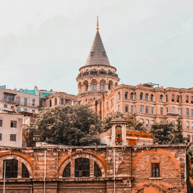 an old building in a big city with a church on top