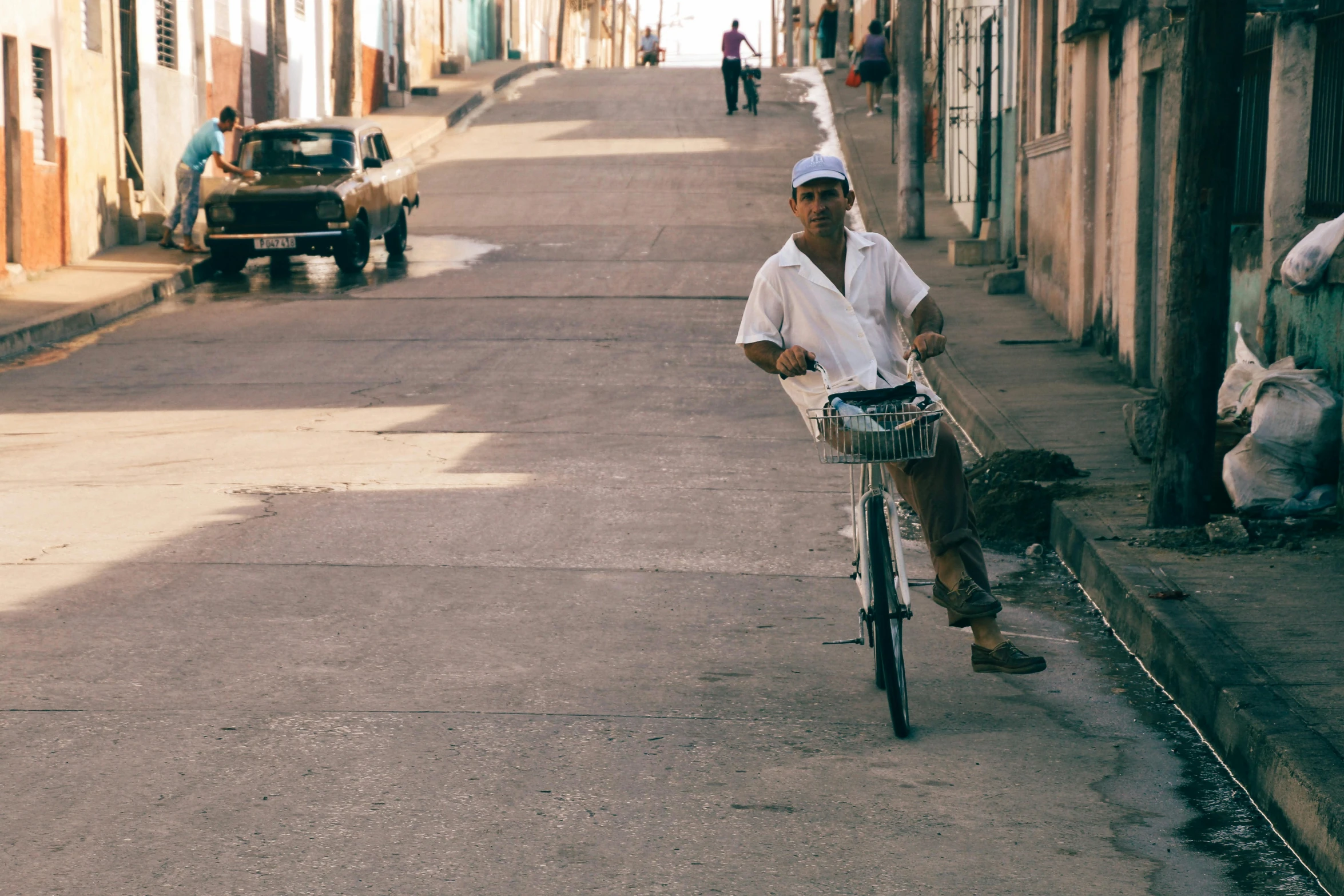 a person riding a bicycle on an old street