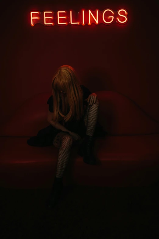 a woman sitting on top of a red couch