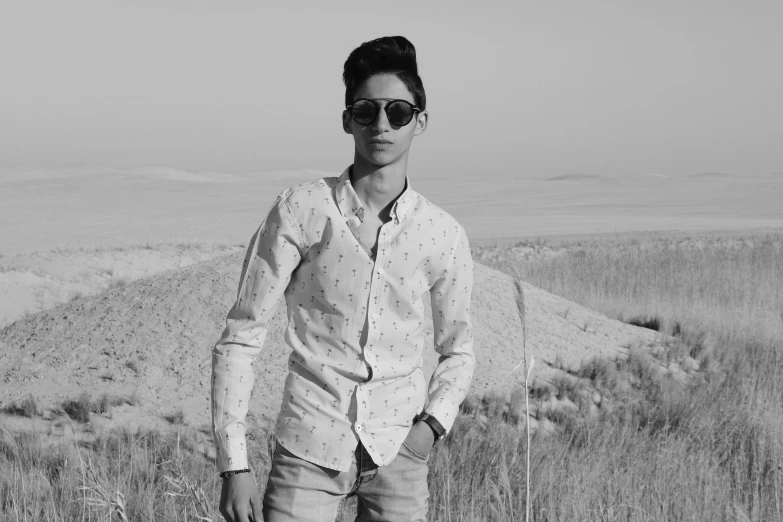 a man standing in front of some dry grass