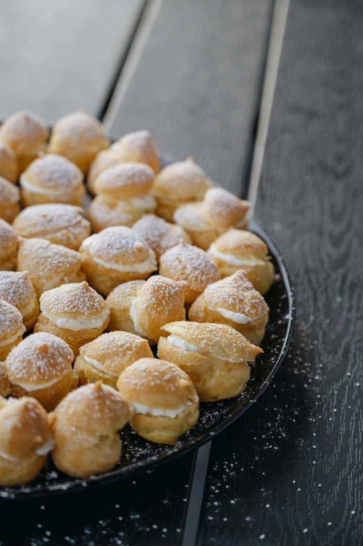 the platter is filled with cookies covered in powdered sugar