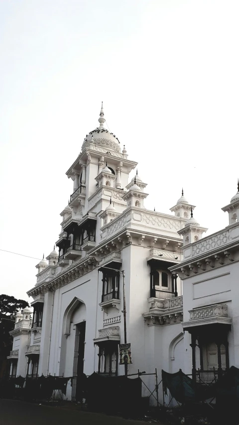 a white building is standing in the sun