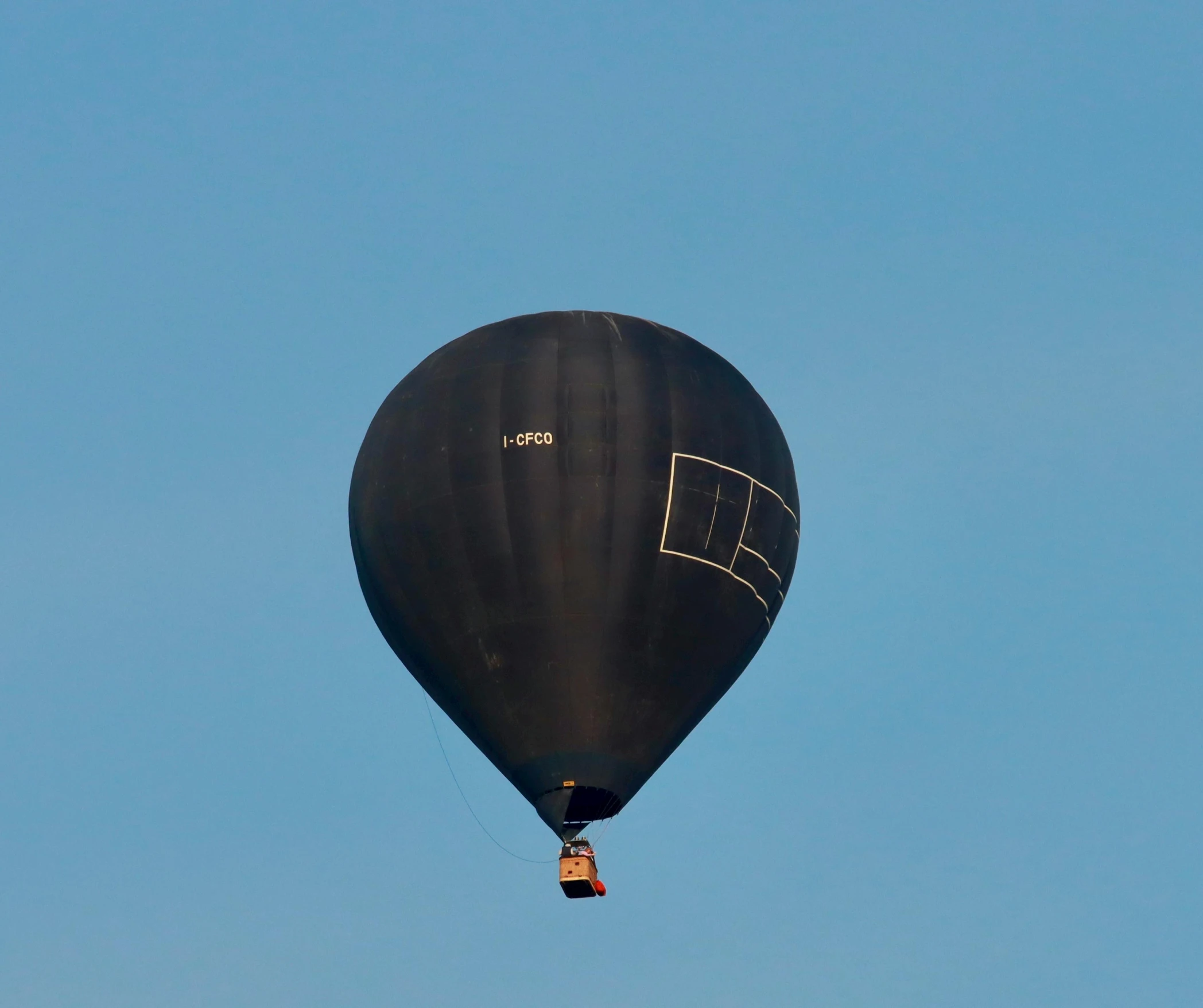an image of a black balloon flying in the sky