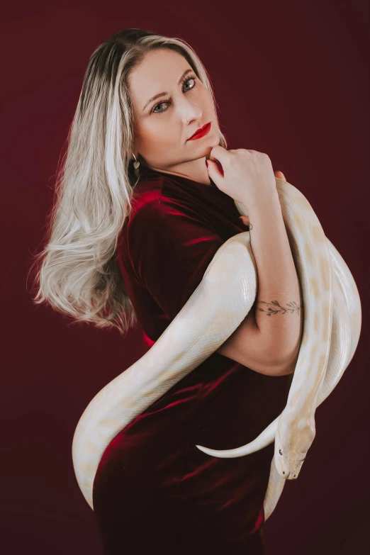 the woman is posing with a white snake skin design