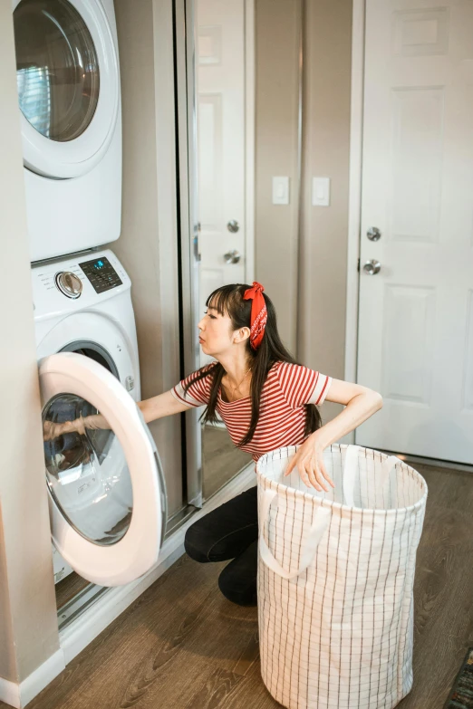 a woman in front of a stack of washers