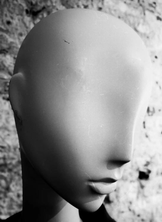 an up close view of a mannequin head with no hair