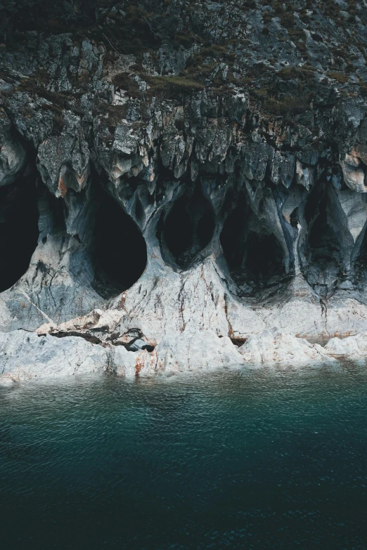 a number of small holes in a mountain