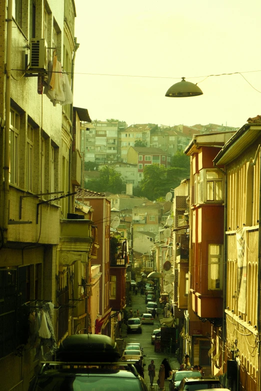 the view down a very narrow road that is in front of many apartment buildings