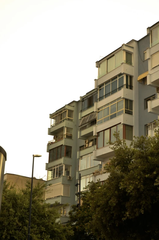 a tall building with trees around it and a clock