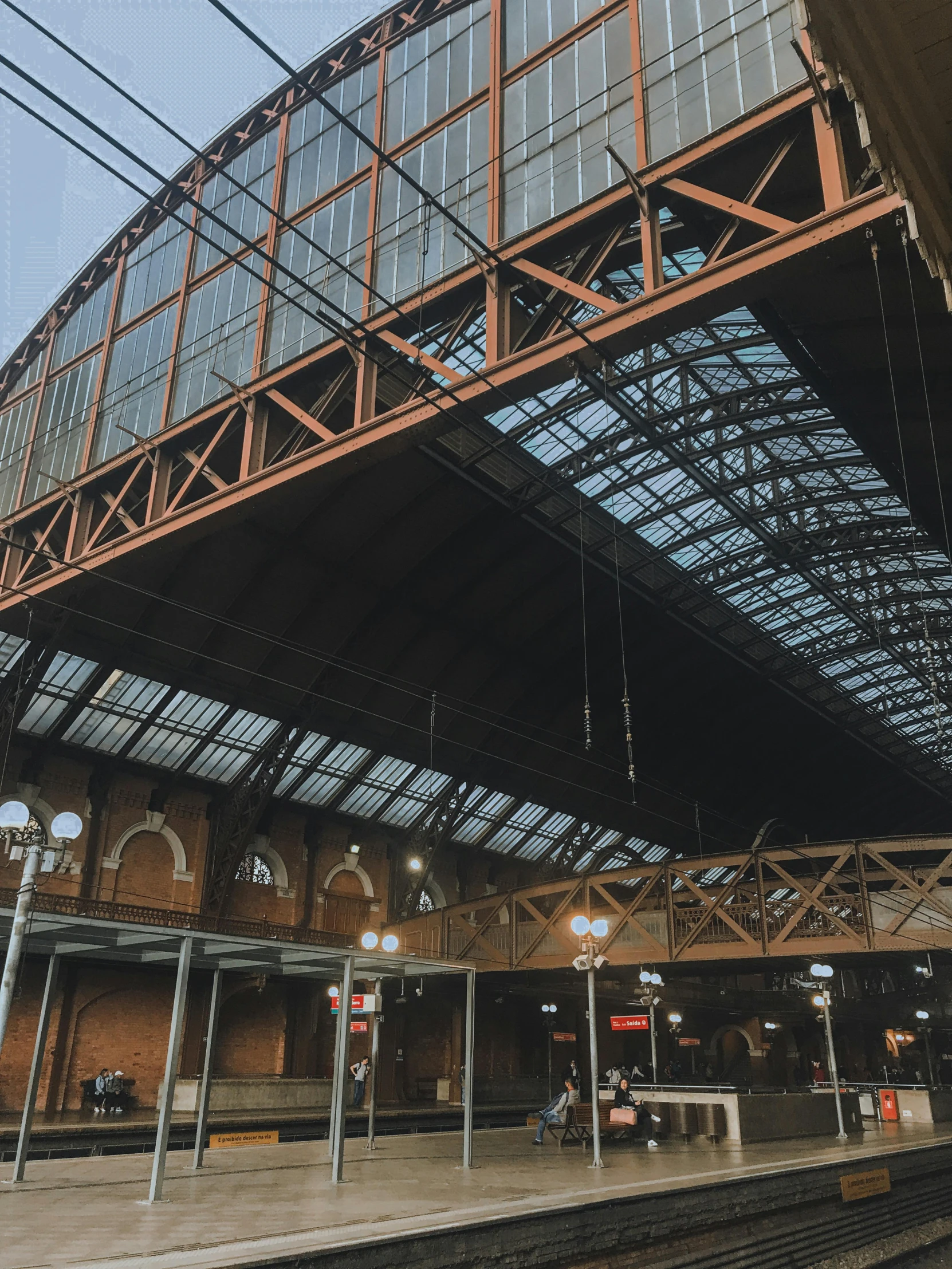 a train station with a bridge over the train tracks