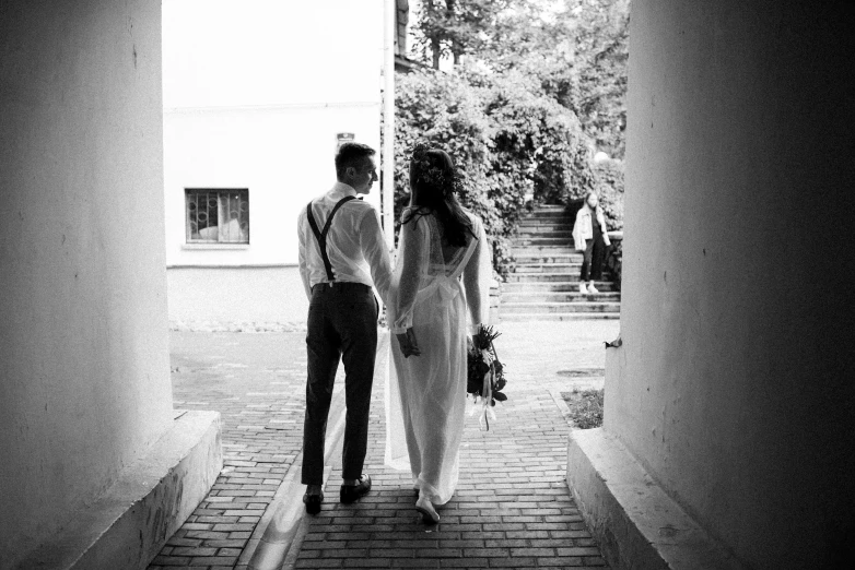 a young man standing next to a woman near trees