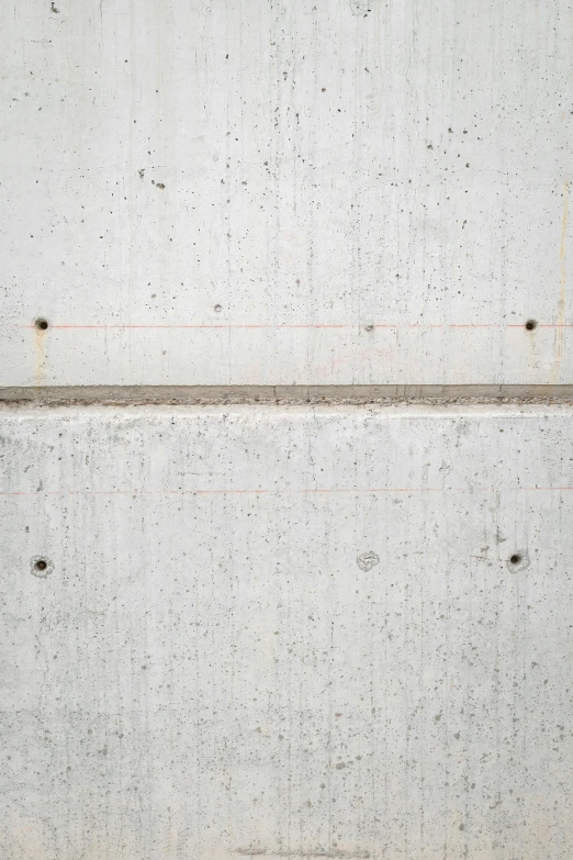 the texture of concrete, with a metal border, and small holes and scratches on it