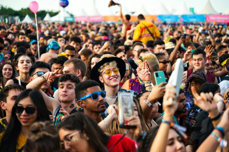 a crowd of people watching a performance with their phones