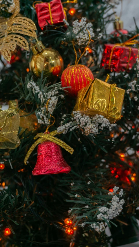 a decorated christmas tree with golden ornaments and gifts