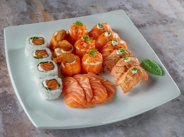 a plate of sushi and a shrimp roll