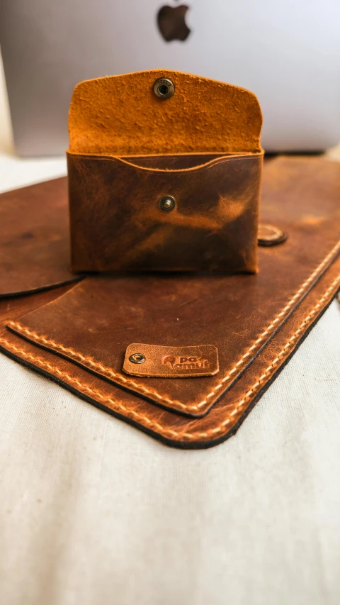 a piece of leather sits on top of a white desk