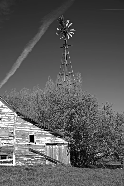 the old white barn has a windmill in it