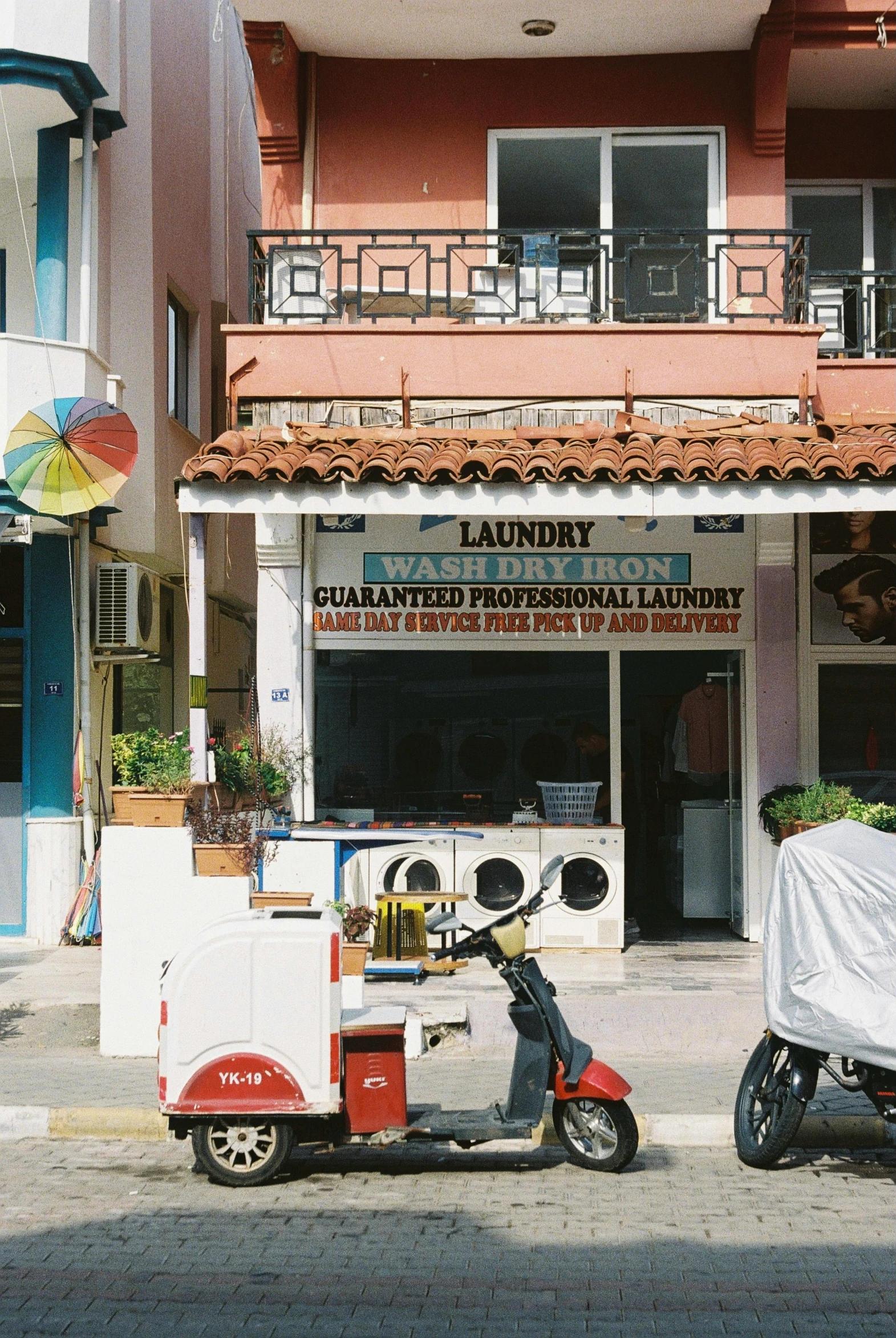 a motor scooter is parked near a bakery