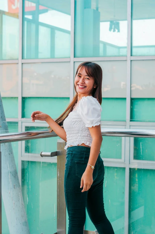 smiling woman with a white shirt and green pants