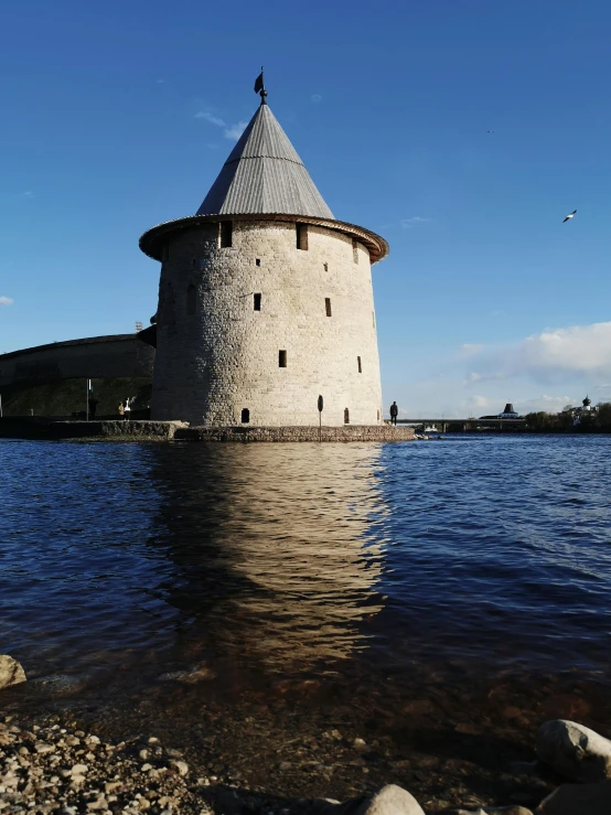 a large water tower standing in the middle of a lake