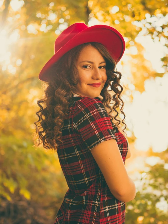 a girl standing in front of some trees