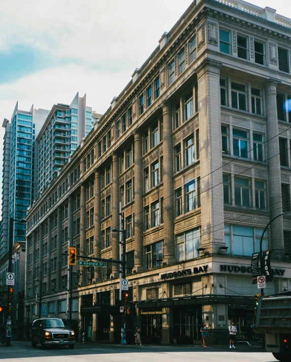 a street view of an old apartment building and surrounding streets