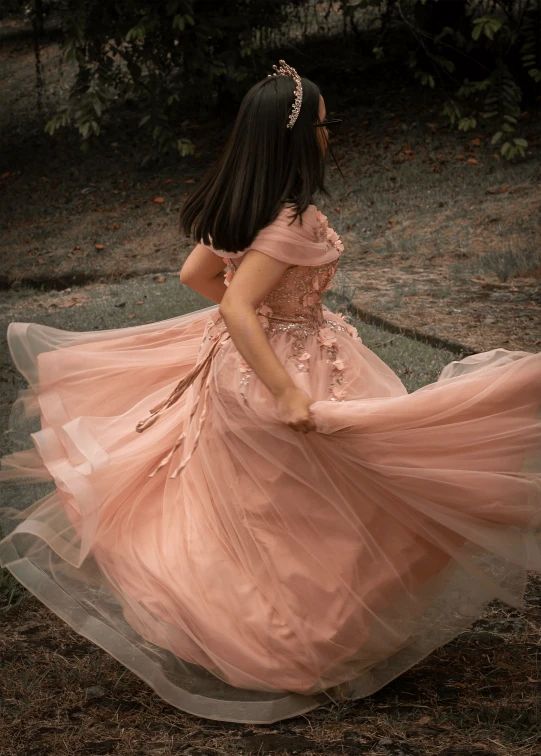 woman wearing peach colored dress with flowing veil