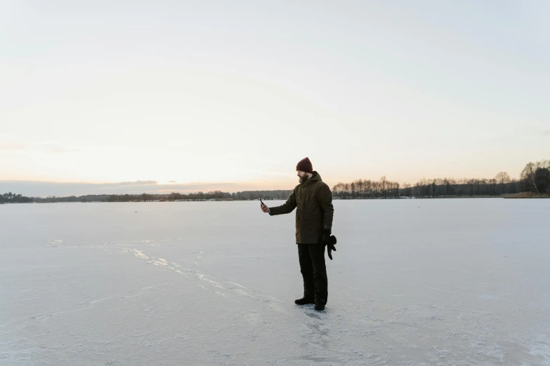 a person on a frozen lake holding soing