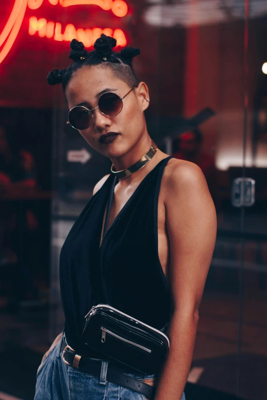 a young woman in sunglasses and a purse