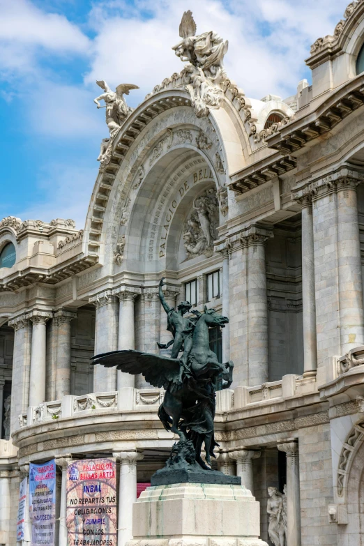 a statue in front of an ornate building