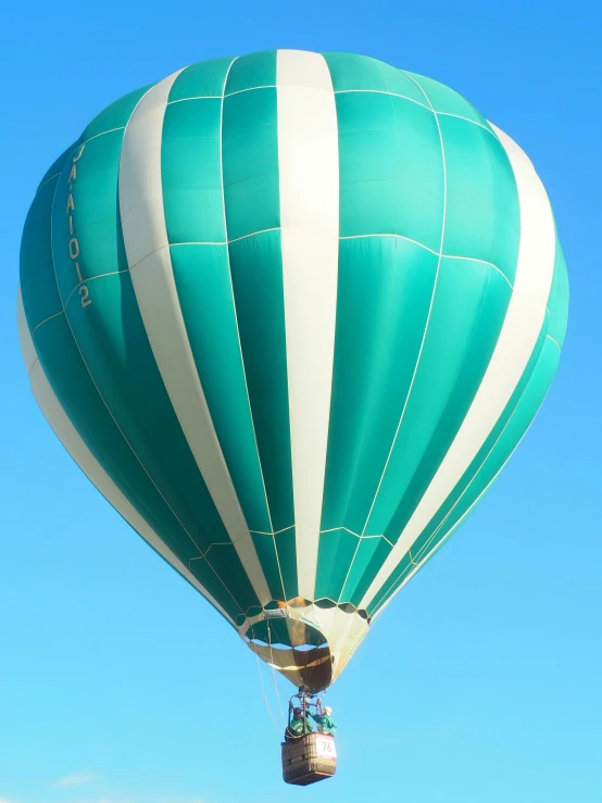 a  air balloon up in the air with blue sky in background