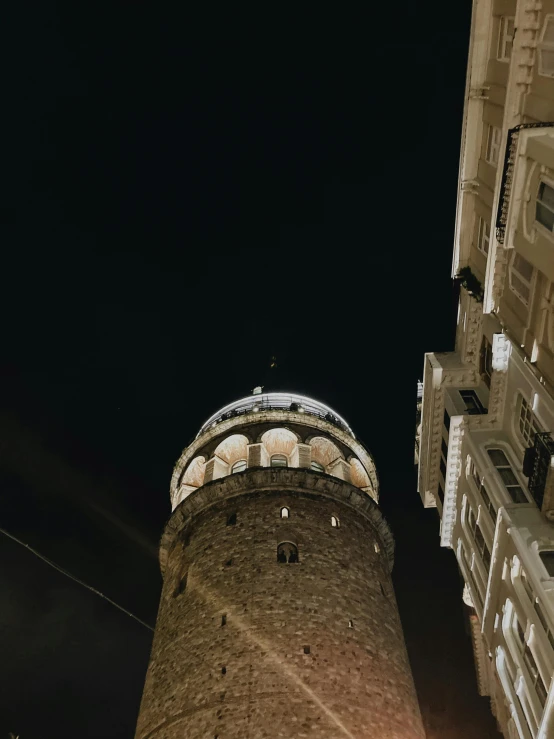 a tower is shown at night on a city street