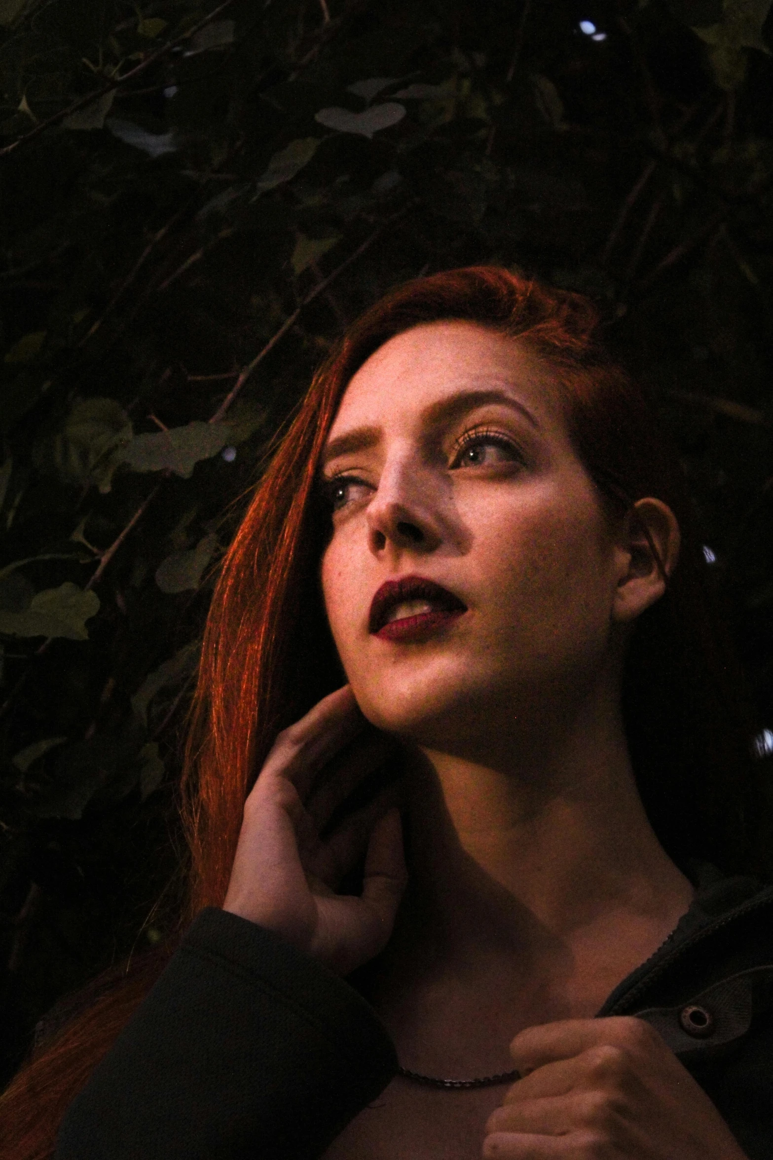 a woman with red hair wearing a black shirt