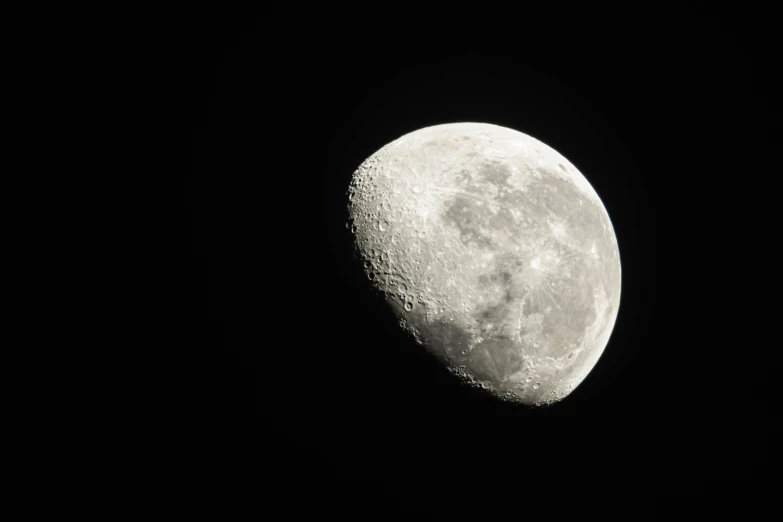 the moon as seen from a distance with a black background