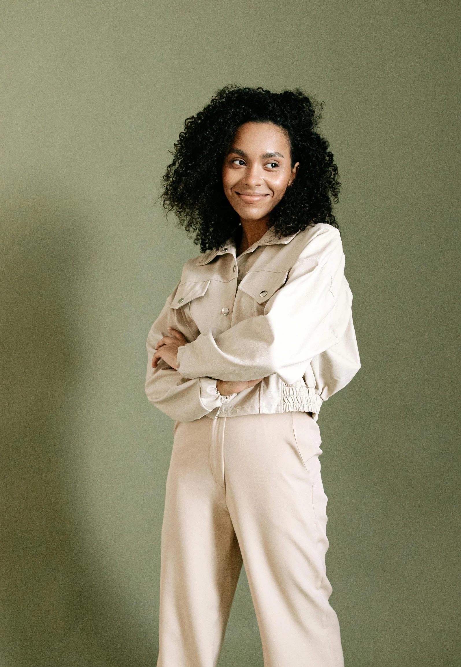 a woman wearing cream clothing and smiling