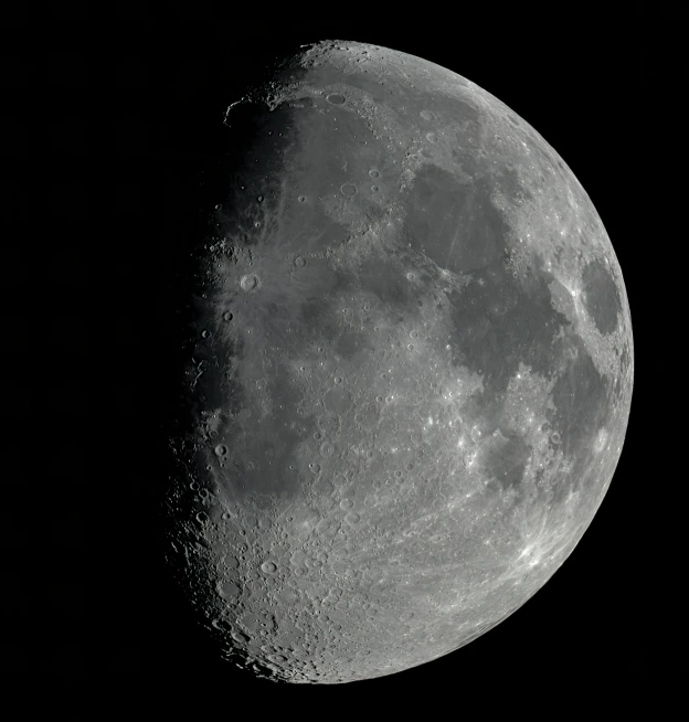 the moon's profile in black and white, with dark space behind it