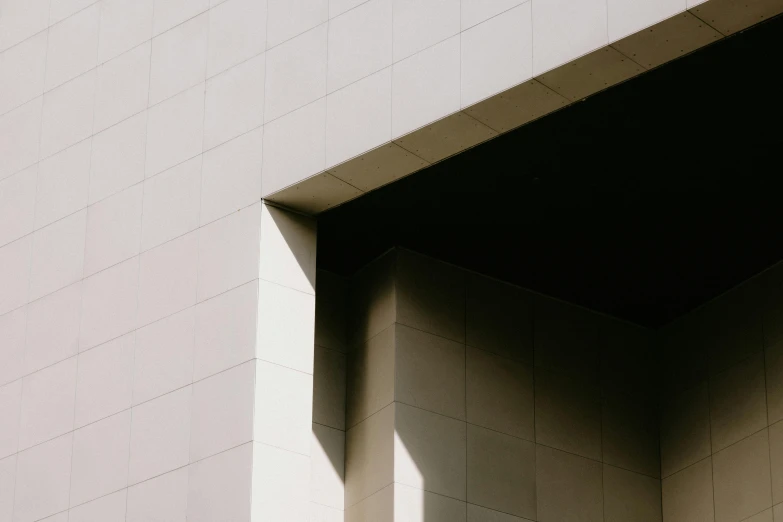 the shadow of a white wall on a building