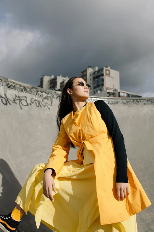 the woman is in yellow and black wearing rainwear