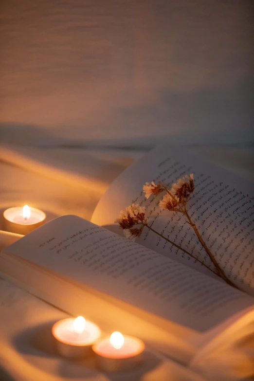 the candles are lit in the dark and on top of the comforter