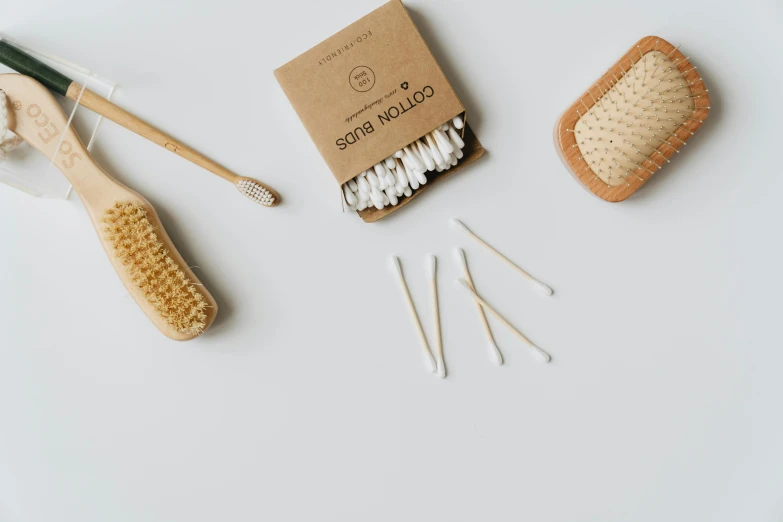 a small package of bamboo brushes sits on the table with cotton swabs