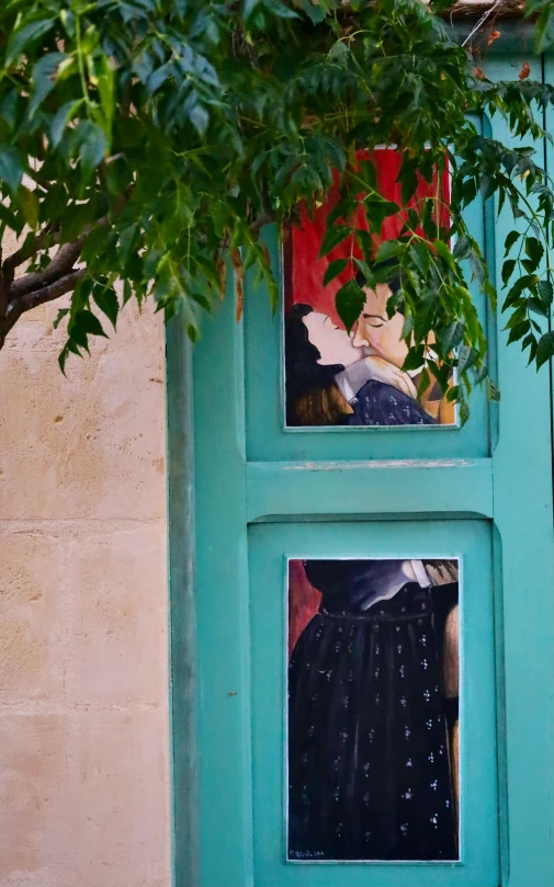 a tree near a closed door with woman in front