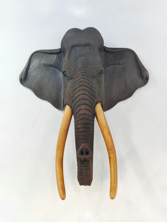 a fake elephant head mounted to the wall