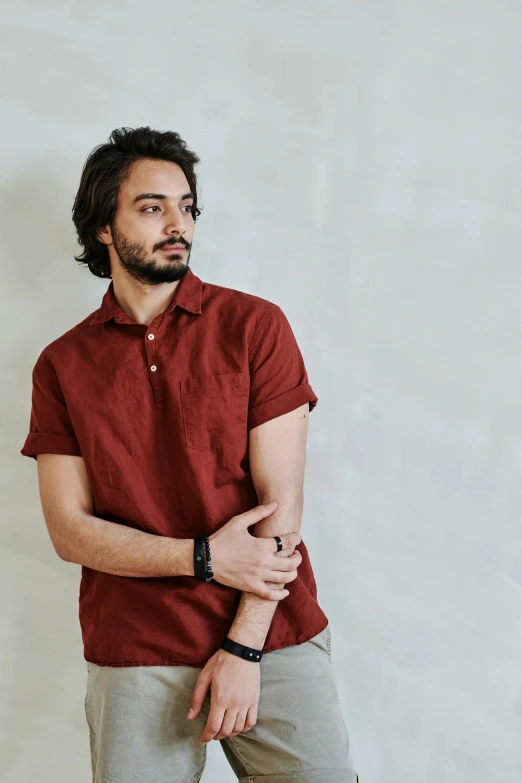 a man is standing and posing with his hand in his pocket